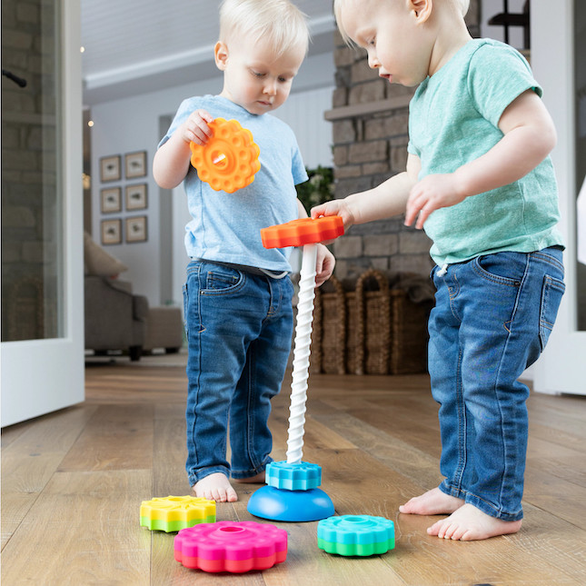 toddler lining up toys